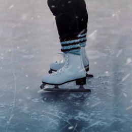a person standing on skates on ice