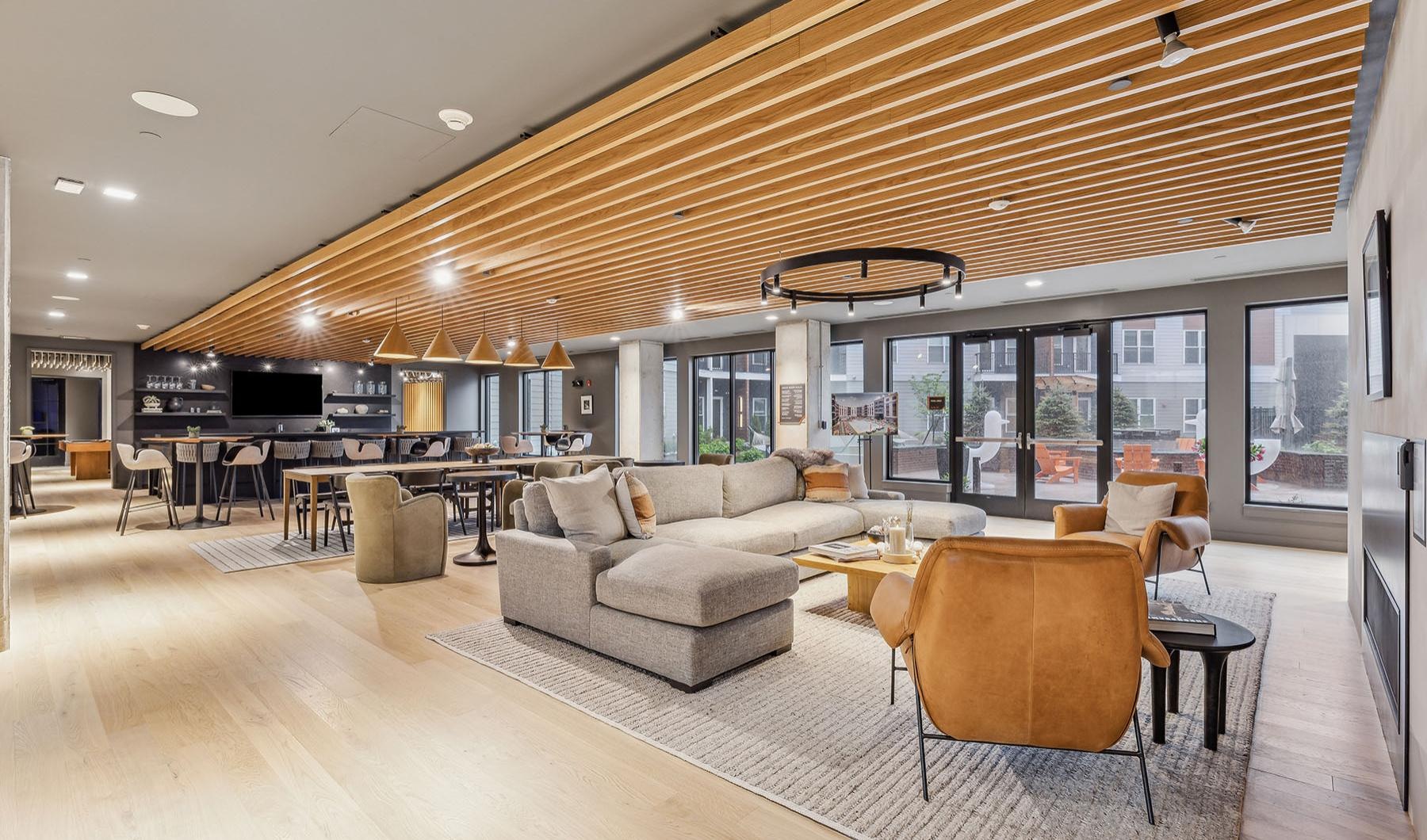 a clubroom with couches, tables and chairs